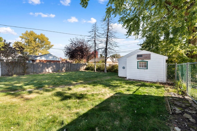 view of yard featuring a storage shed, a fenced backyard, and an outdoor structure