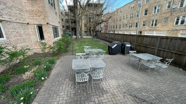 view of patio / terrace featuring outdoor dining space, area for grilling, and fence