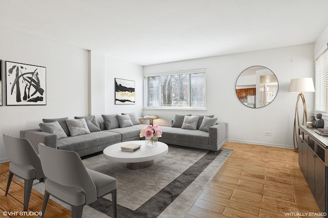 living room featuring light wood-style flooring and baseboards