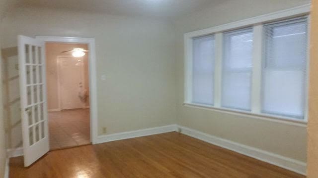 unfurnished room featuring wood finished floors and baseboards