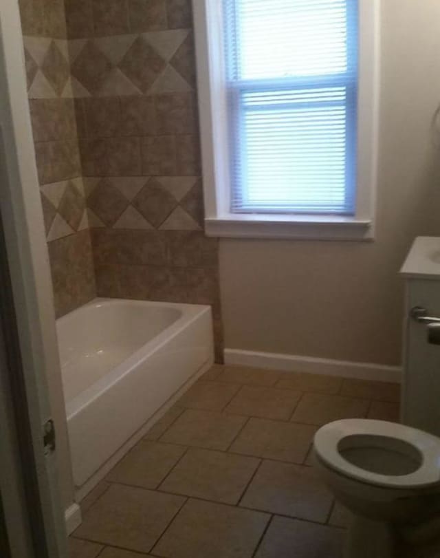 full bathroom featuring tile patterned flooring, toilet, vanity, and baseboards