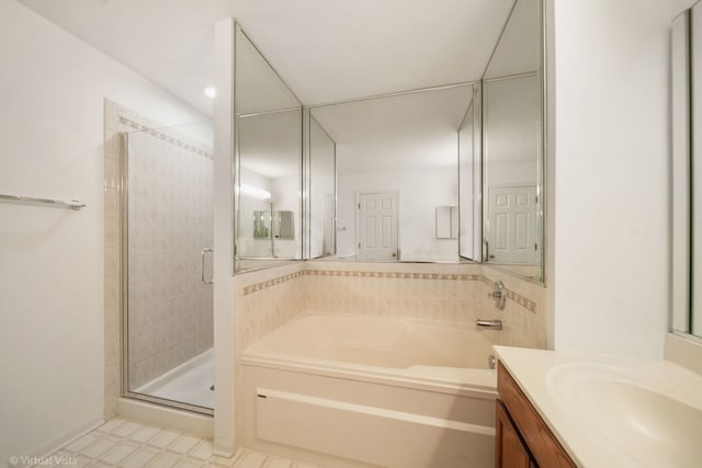 bathroom with a garden tub, a shower stall, and vanity