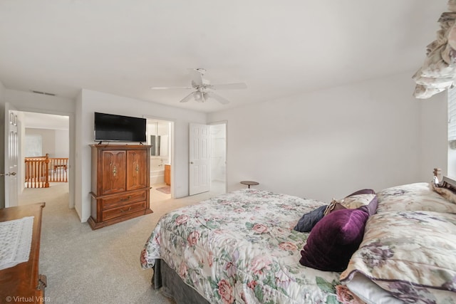 bedroom with a ceiling fan, light carpet, connected bathroom, and visible vents