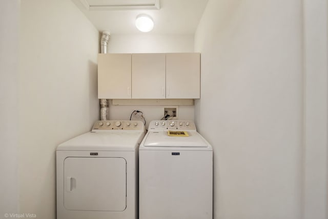 laundry area with cabinet space and washer and clothes dryer