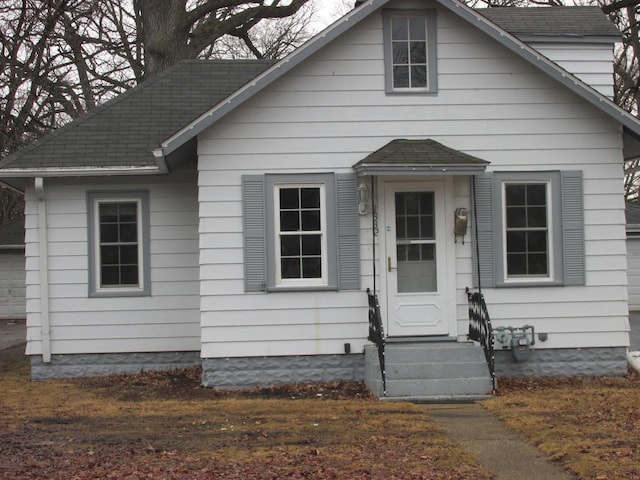 bungalow-style house featuring a shingled roof and entry steps