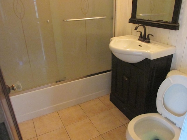 bathroom featuring toilet, tile patterned flooring, tub / shower combination, and vanity