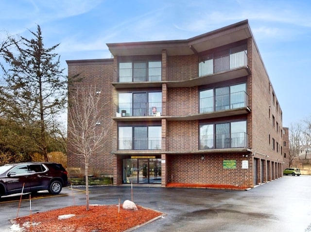 view of property featuring uncovered parking