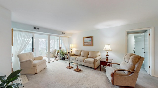 living area with light carpet and visible vents