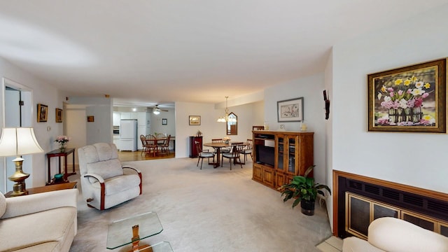 living room with a ceiling fan and light carpet