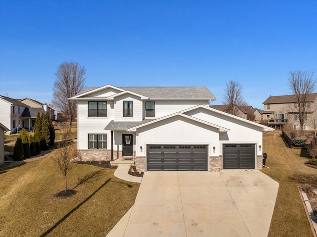 traditional-style home featuring a shingled roof, concrete driveway, a front lawn, a garage, and stone siding