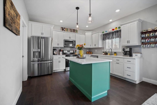 kitchen featuring a sink, decorative backsplash, white cabinets, and stainless steel appliances