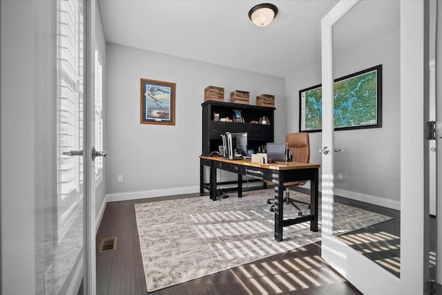 home office with visible vents, baseboards, and wood finished floors