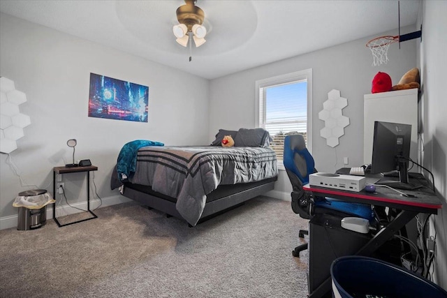 carpeted bedroom featuring baseboards and ceiling fan