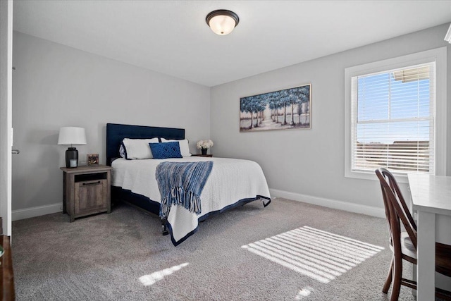 bedroom with baseboards and carpet