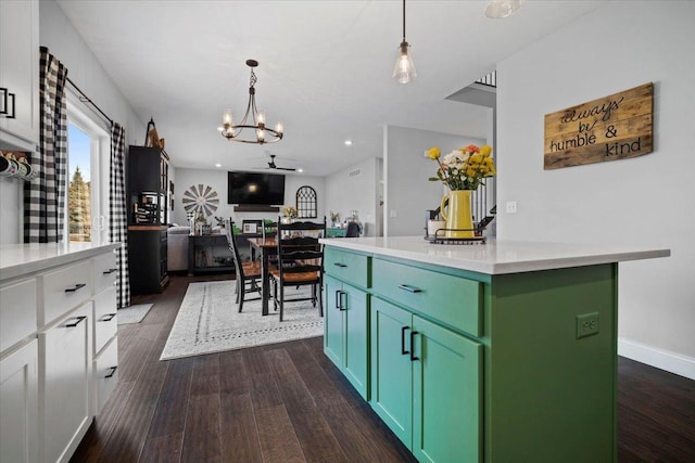 kitchen with light countertops, dark wood-style floors, and green cabinetry