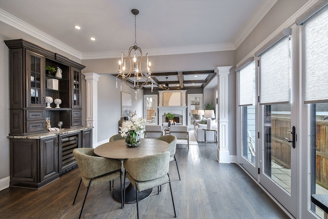 dining area featuring beverage cooler, dark wood-style floors, a wealth of natural light, and an inviting chandelier