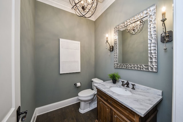 bathroom featuring wood finished floors, baseboards, ornamental molding, toilet, and a chandelier