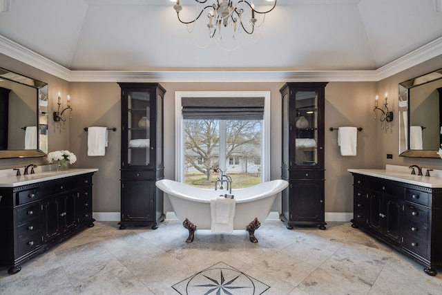 full bathroom with lofted ceiling, a notable chandelier, two vanities, and a freestanding bath