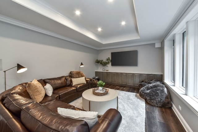 living area featuring a tray ceiling, dark wood-style floors, recessed lighting, crown molding, and baseboards