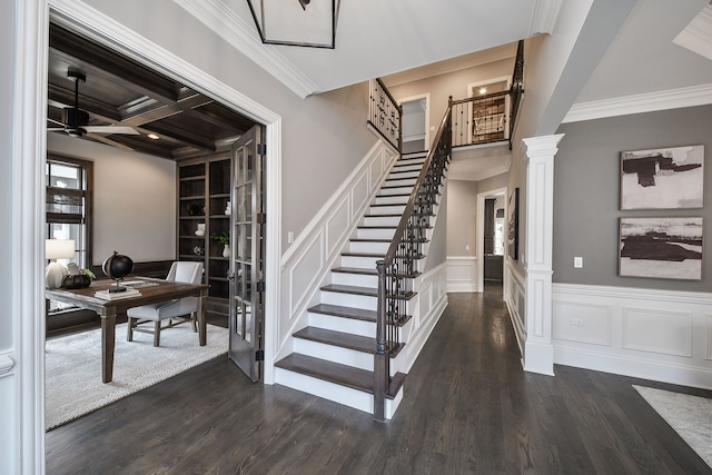 stairs with french doors, crown molding, ceiling fan, and wood finished floors