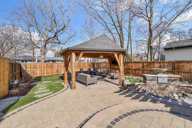 view of patio with a gazebo, an outdoor hangout area, and a fenced backyard