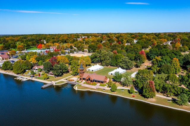 aerial view with a water view and a wooded view