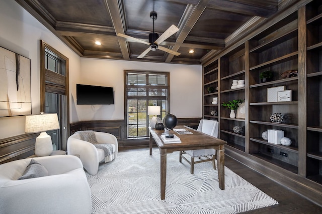 office space with beamed ceiling, built in shelves, a ceiling fan, wainscoting, and crown molding