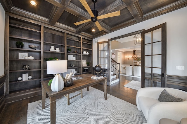 office space with beamed ceiling, built in shelves, coffered ceiling, and wood finished floors