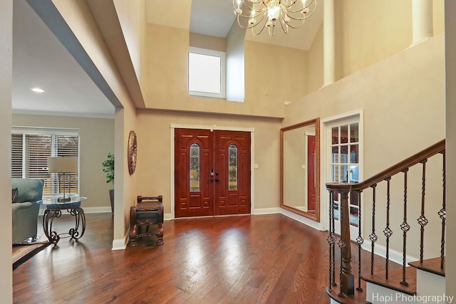 entrance foyer with stairs, baseboards, and hardwood / wood-style floors