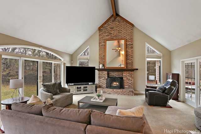 carpeted living area featuring beam ceiling, a brick fireplace, french doors, and high vaulted ceiling