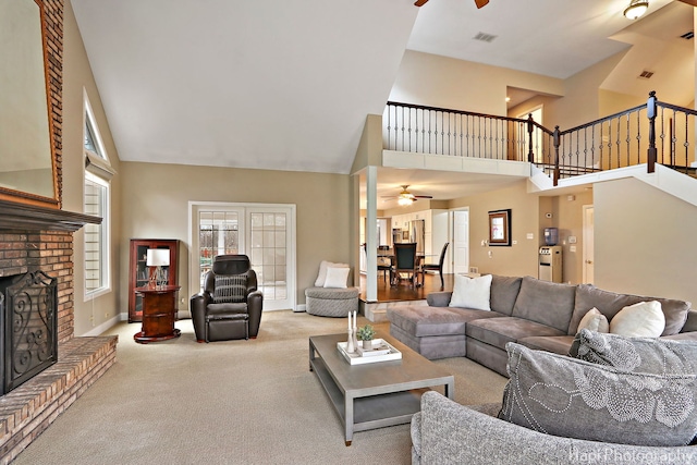 carpeted living room featuring a fireplace, baseboards, and ceiling fan