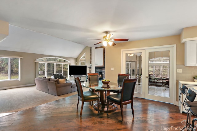 dining room featuring dark wood-style floors, french doors, a ceiling fan, and lofted ceiling