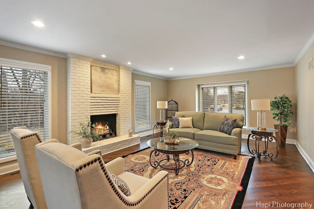 living area with baseboards, recessed lighting, a fireplace, dark wood-type flooring, and crown molding