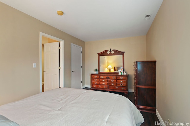 bedroom with visible vents and baseboards