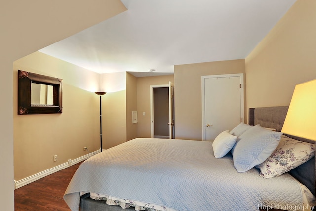 bedroom featuring dark wood-type flooring and baseboards