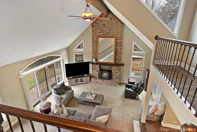 living room with baseboards, ceiling fan, stairway, beamed ceiling, and a fireplace