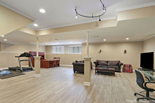 workout room featuring visible vents, light wood-type flooring, crown molding, and baseboards