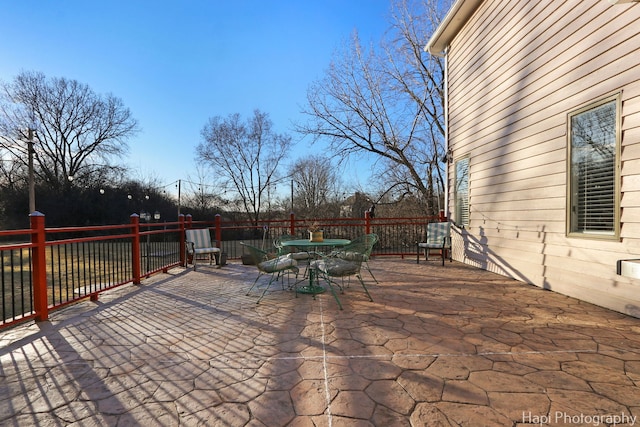 view of patio / terrace with outdoor dining space and fence