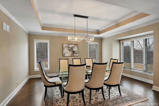 dining space with visible vents, baseboards, a raised ceiling, and dark wood-type flooring