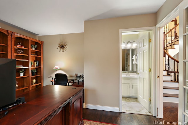 office space with wood finished floors, baseboards, and a sink