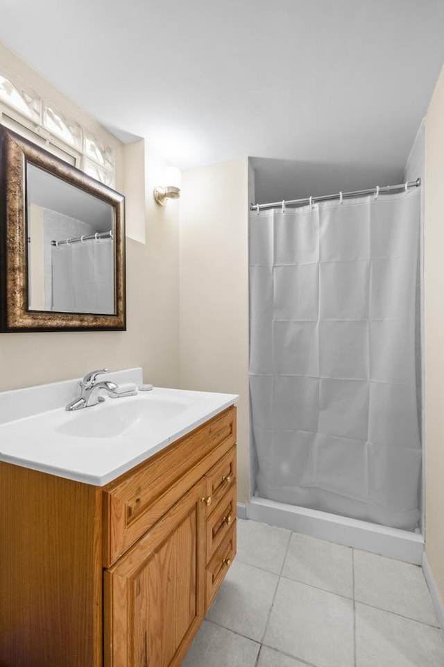 bathroom featuring curtained shower, vanity, and tile patterned floors