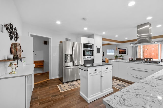 kitchen featuring stainless steel appliances, white cabinetry, visible vents, and island range hood