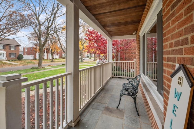 balcony featuring covered porch and a residential view