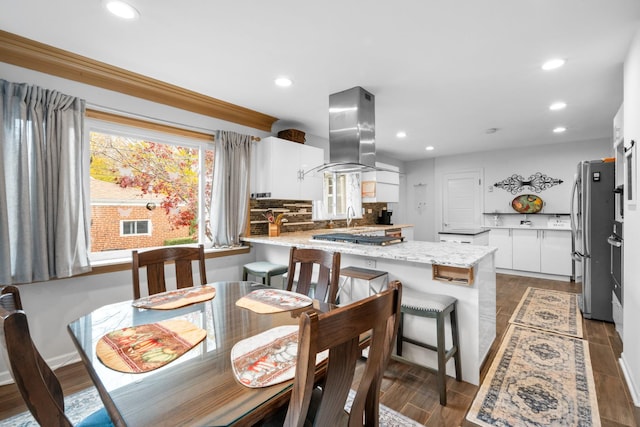 dining area featuring wood finished floors and recessed lighting