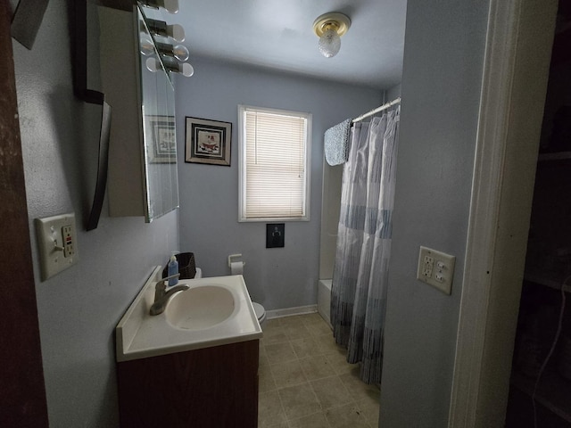 bathroom with baseboards, shower / tub combo with curtain, and vanity