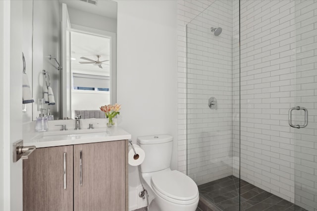 full bathroom featuring vanity, a ceiling fan, visible vents, a shower stall, and toilet