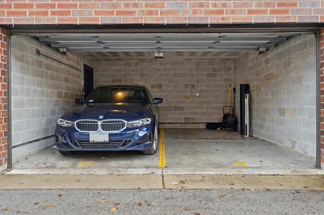 parking garage with concrete block wall and a garage door opener