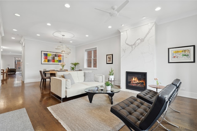 living room with recessed lighting, a high end fireplace, dark wood finished floors, and crown molding