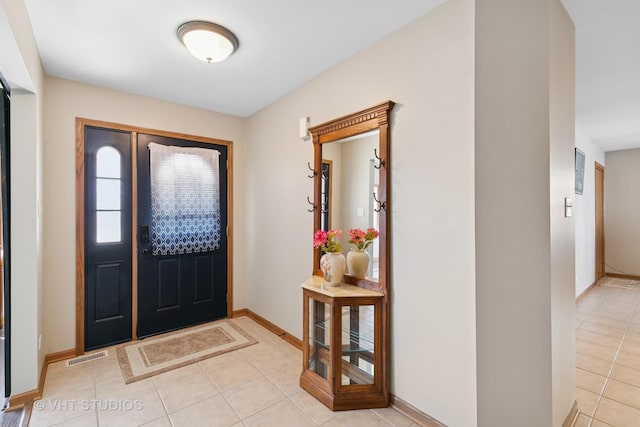 entryway with light tile patterned flooring, visible vents, and baseboards