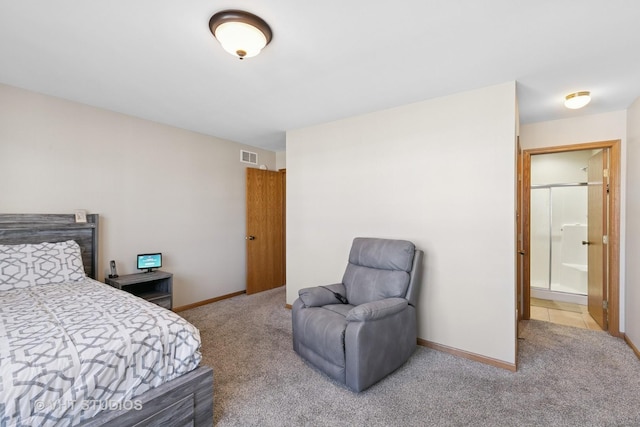 bedroom featuring carpet floors, visible vents, ensuite bath, and baseboards